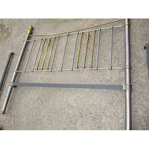 342 - A vintage polished iron and brass double bed frame, in good useable condition with use related marks... 