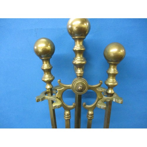 216 - A vintage brass 3 piece companion set on stand with a set of bellows, some tarnishing so in need of ... 