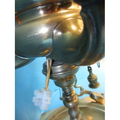 219 - An early 20th century brass 4 branch candle stick, having been converted to electric but needs a rew... 