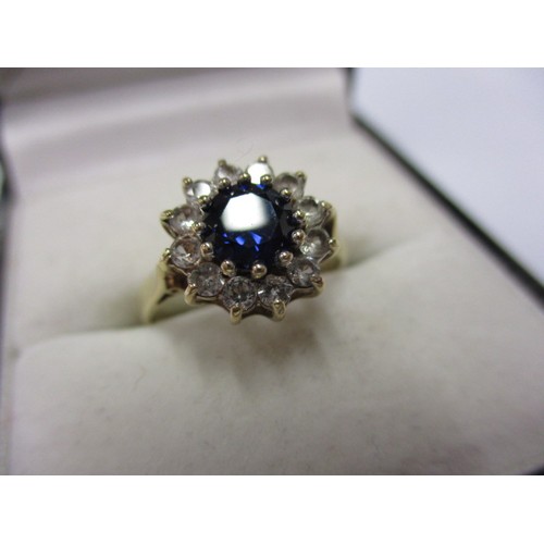 8 - A 9ct yellow gold daisy ring with diamonds and central rich blue sapphire, approx. ring size M appro... 