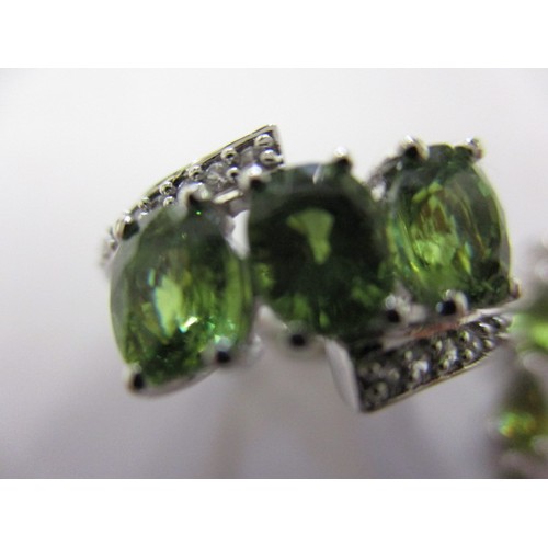 2 - A 9ct white gold ring with zircon set shoulders and 3 green garnets to centre and a matching necklac... 