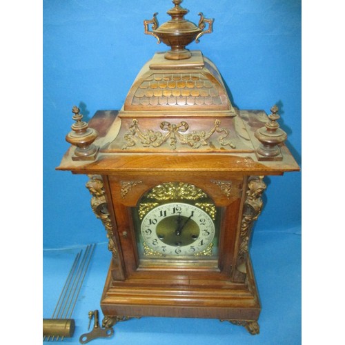 186 - An Edwardian walnut cased mantle clock with gilt metal mounts and turned spandrils, in need of resto... 