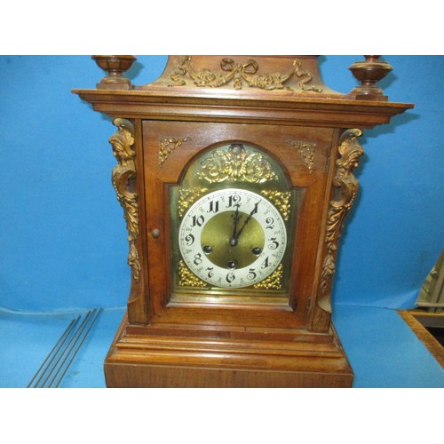 186 - An Edwardian walnut cased mantle clock with gilt metal mounts and turned spandrils, in need of resto... 