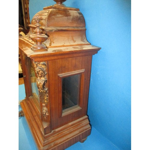 186 - An Edwardian walnut cased mantle clock with gilt metal mounts and turned spandrils, in need of resto... 