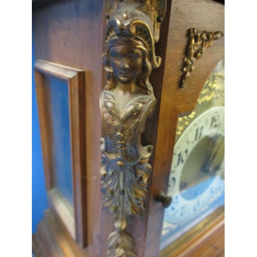 186 - An Edwardian walnut cased mantle clock with gilt metal mounts and turned spandrils, in need of resto... 