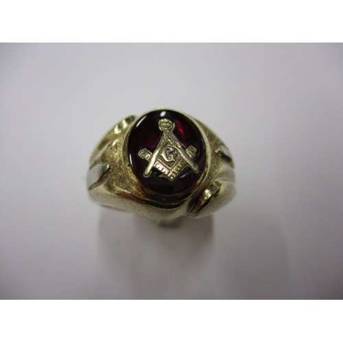 20 - A gents 10k gold ring with masonic emblem on a rich red enamel ground, approx. weight 8.6g, approx. ... 