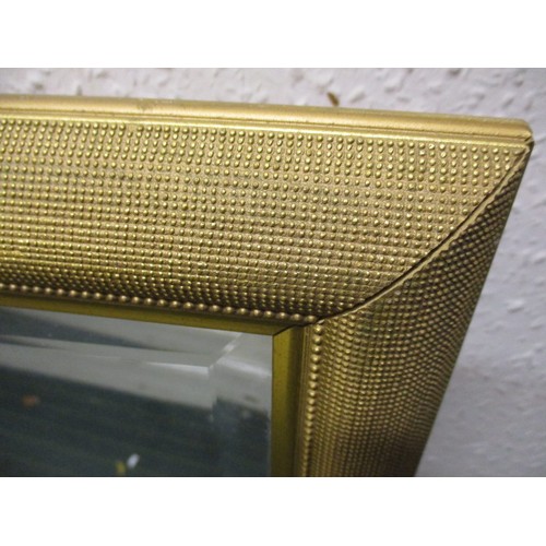 242 - A gilt framed bevelled glass wall mirror, approx. dimensions 110x85cm, in good clean condition