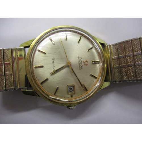 79 - A vintage Omega Geneve automatic wrist watch with date window, in current working order with a small... 