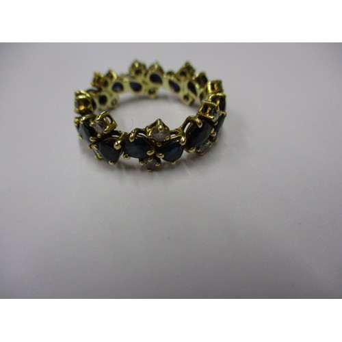 12 - An unmarked but tested as gold ring, set with diamonds and sapphires, approx. weight 4.4g approx. ri... 