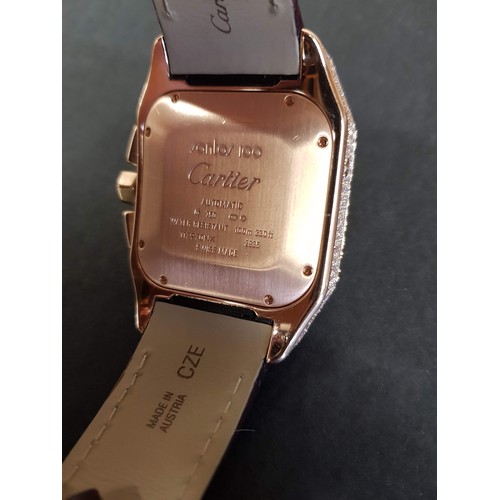 67 - A Cartier 18k pink gold automatic chronograph large Santos 100 watch model 2935, having numerous dia... 