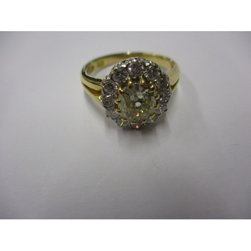 15 - An 18ct yellow gold diamond cluster ring, the central yellow stone measuring approx. 7.62mmx6.88mm a... 