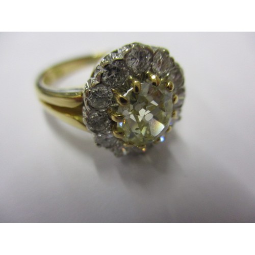 15 - An 18ct yellow gold diamond cluster ring, the central yellow stone measuring approx. 7.62mmx6.88mm a... 