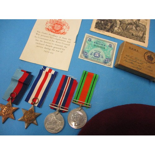 169 - A WWII paratroopers beret, with 4 medal group and cloth badges, all in good used condition