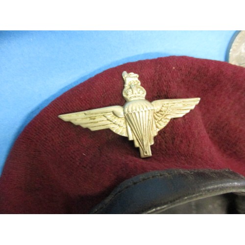 169 - A WWII paratroopers beret, with 4 medal group and cloth badges, all in good used condition