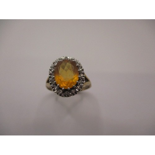 11 - A 9ct yellow gold dress ring with central Citrine surrounded by small diamonds, approx. ring size Q,... 