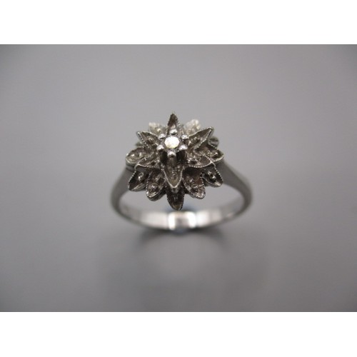 13 - An 18ct white gold daisy ring, approx. ring size ‘M’ approx. weight 3.5g in pre-owned condition with... 