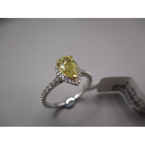 20 - A 9ct white gold and diamond ring, the central fancy yellow pear shape stone measuring approx. 0.93c... 