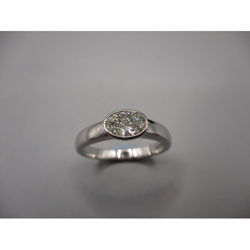 26 - An 18ct white gold, diamond solitaire ring, set with an oval shaped diamond, approximately .62 of a ... 