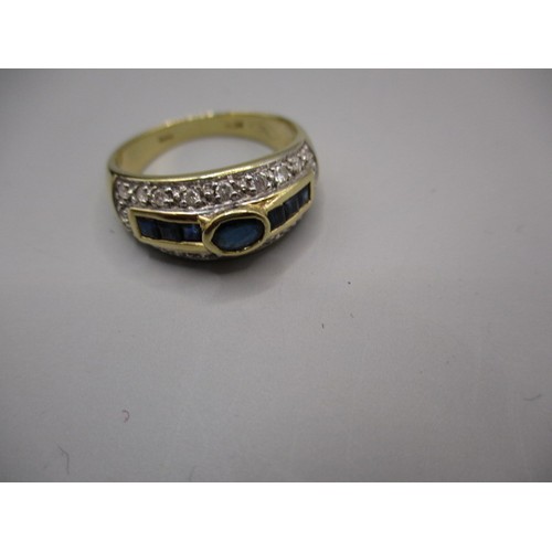 27 - An 18ct yellow gold ring with central band of sapphires surrounded by pave set diamonds, approx. rin... 
