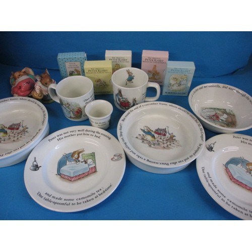 A quantity of Beatrix Potter ceramics and miniature Beatrix Potter and Winnie the Pooh books. No observed damage or restoration.