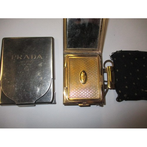 prada cigarette case A vintage Kigu compact / cigarette case and a Prada cigarette case with  integral lighter, both in go
