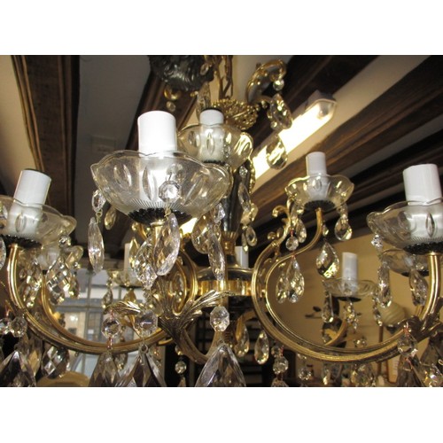 303 - A 12 lamp brass and lead crystal chandelier, approx. drop of body without chain 57cm approx. width 6... 