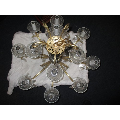 303 - A 12 lamp brass and lead crystal chandelier, approx. drop of body without chain 57cm approx. width 6... 