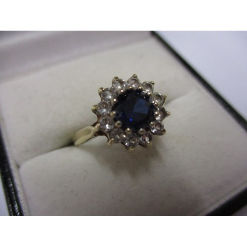 5 - A 9ct yellow gold daisy ring with diamonds and central rich blue sapphire, approx. ring size M appro... 
