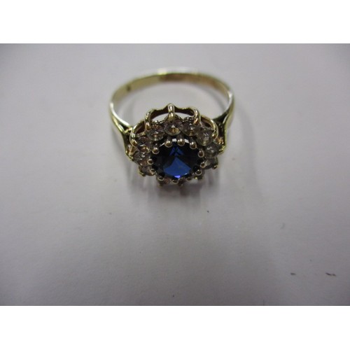 5 - A 9ct yellow gold daisy ring with diamonds and central rich blue sapphire, approx. ring size M appro... 