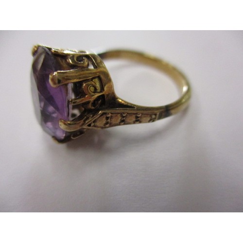 6 - An antique un-marked yellow metal ring with large single amethyst, approx. ring size H ½ showing sig... 