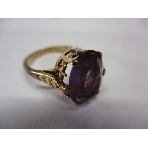 6 - An antique un-marked yellow metal ring with large single amethyst, approx. ring size H ½ showing sig... 