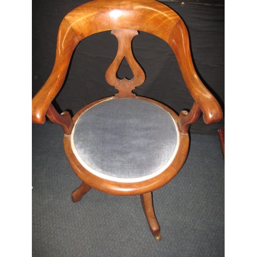 323 - An early 20th century swivel office chair on brass castors, having had use-related restoration some ... 