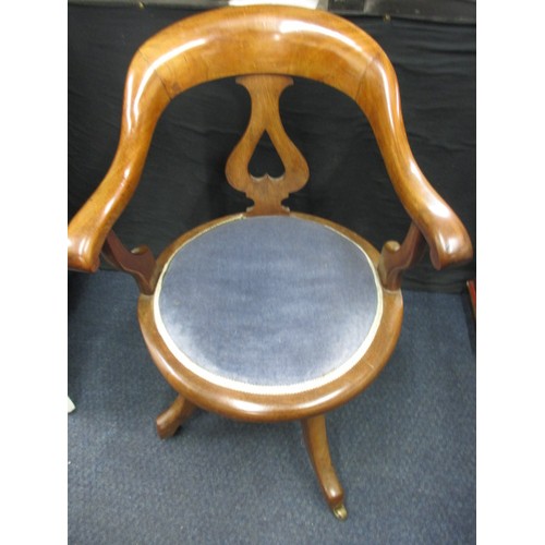 323 - An early 20th century swivel office chair on brass castors, having had use-related restoration some ... 