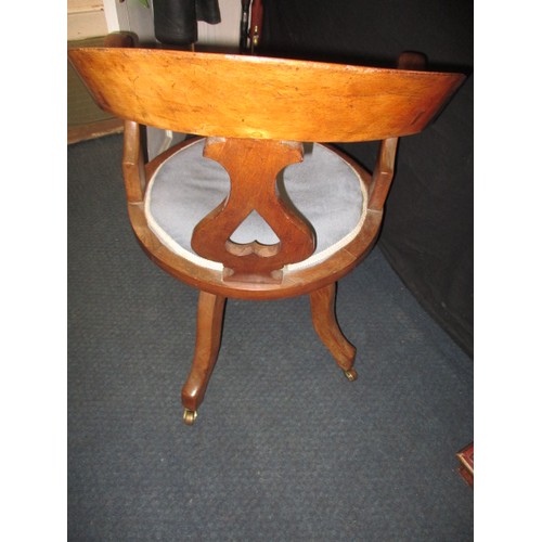 323 - An early 20th century swivel office chair on brass castors, having had use-related restoration some ... 