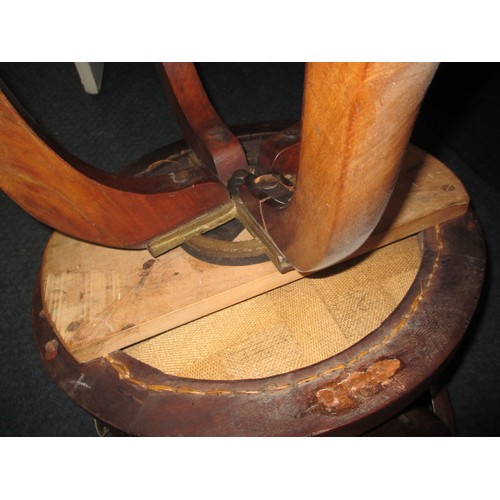 323 - An early 20th century swivel office chair on brass castors, having had use-related restoration some ... 