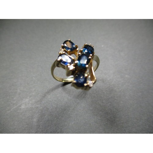 18 - A stylized yellow gold ring set with sapphires and diamonds, approx. ring size ‘P’ having an off-set... 