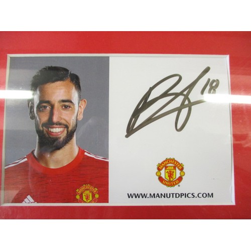 284 - A framed photo and signed card of Manchester United Number 18 B. Fernandes, approximate frame size 4... 