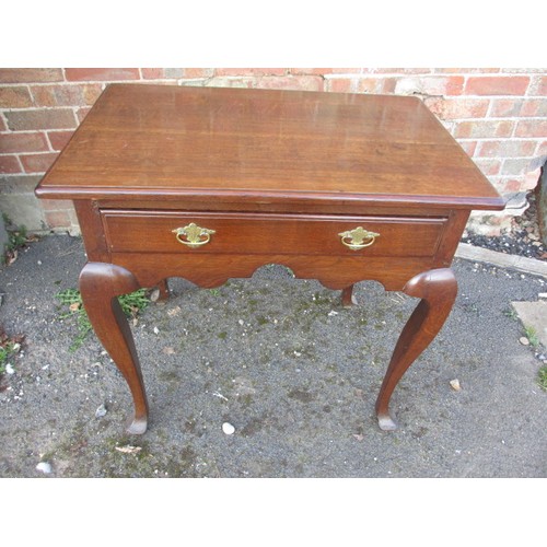 An early 19th century oak lowboy with single frieze drawer and original handles. Approx. length 76cm, width 51cm, height 73cm. In good useable, antique condition with use-related marks