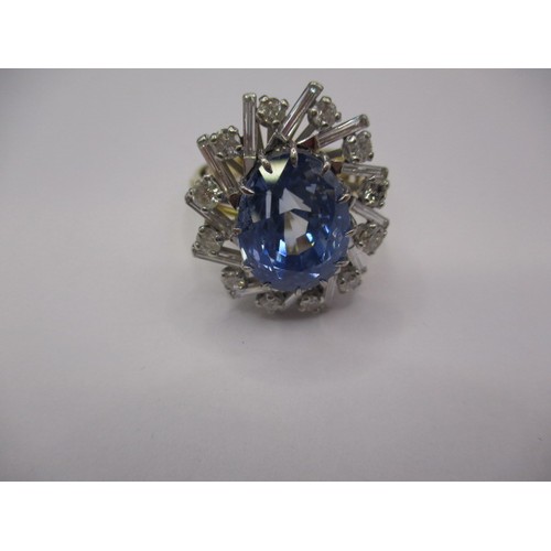 32 - An 18ct yellow and white gold diamond and sapphire ring, the pale blue sapphire is certificated as b... 