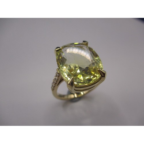 33 - An unmarked yellow gold ring with diamond chip shoulders and a large certificated natural untreated ... 