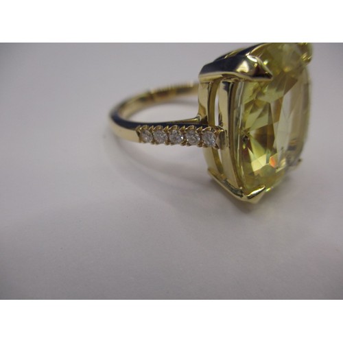 33 - An unmarked yellow gold ring with diamond chip shoulders and a large certificated natural untreated ... 