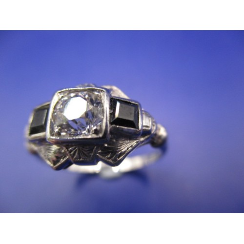 25 - A 1940s Art Deco ring with palladium shank square cut sapphires to shoulders and a central diamond o... 