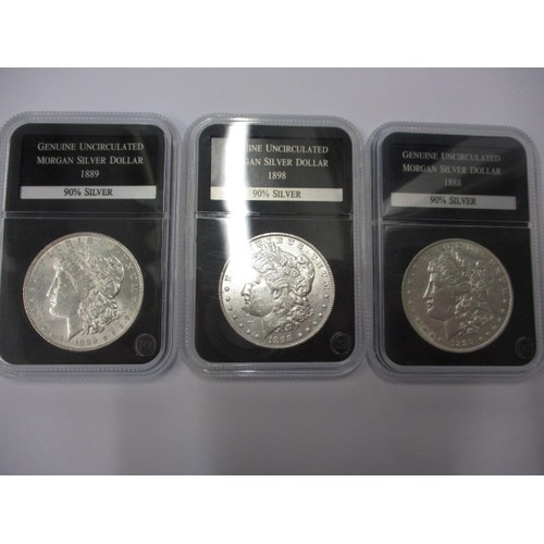 106 - 3 Uncirculated ‘Morgan’ silver dollars, dated 1888-1889-1898, each in a plastic capsule