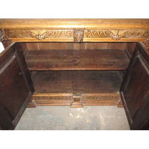 317 - A late 19th century carved oak sideboard, with 2 frieze drawers and cupboards, approx. dimensions: H... 