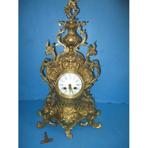 284 - A French brass empire style table clock, having enamel dial and striking on a bell, runs when wound,... 