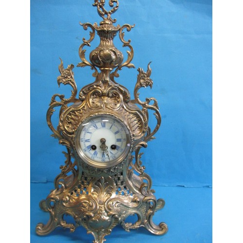 284 - A French brass empire style table clock, having enamel dial and striking on a bell, runs when wound,... 