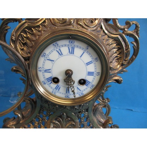 284 - A French brass empire style table clock, having enamel dial and striking on a bell, runs when wound,... 