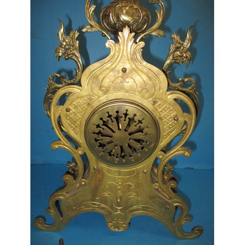 284 - A French brass empire style table clock, having enamel dial and striking on a bell, runs when wound,... 