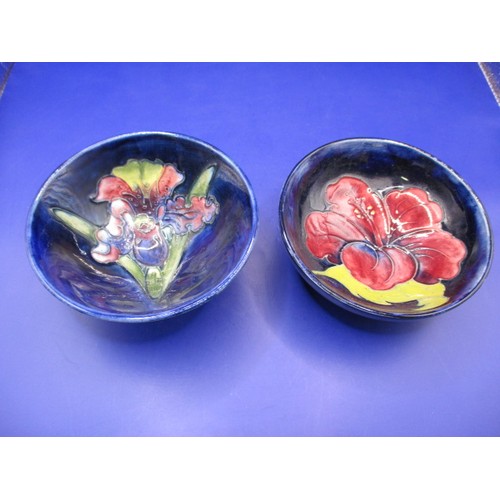 173 - Two vintage Moorcroft bowls with tube lined floral decoration on blue ground, both with no observed ... 