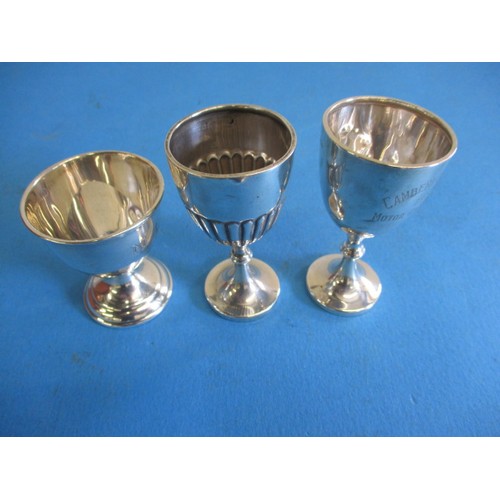 121 - Three sterling silver egg cups, various dates and makers, approx. parcel weight 69.4g, some minor de... 